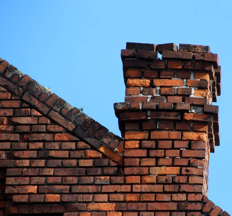 Damaged chimney on an Roseville home showing cracks and missing mortar